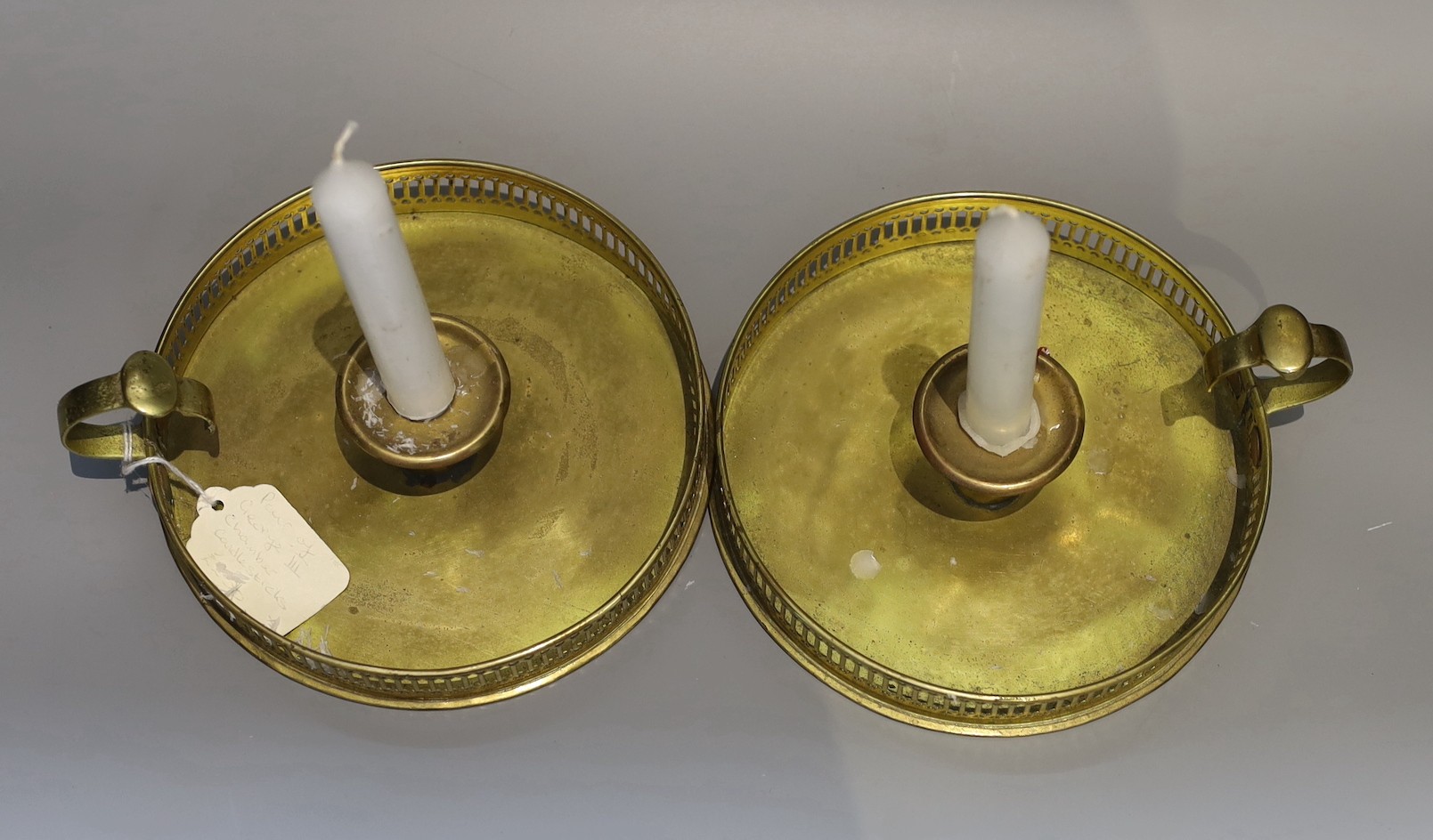 A pair of 19th century circular brass chambersticks, diameter 18cm